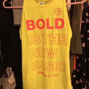 Bright yellow Zumba tank, looks awesome on. Never worn